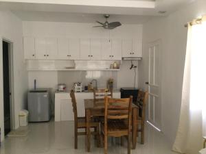 a kitchen with a table and chairs in a room at Gengs Apartment and Nmax Rentals in Dipolog