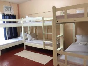 a room with three bunk beds in a room at Azzura Budget Rooms in Zamboanga
