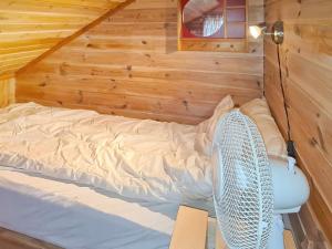 a bedroom with a bed with a fan in it at Holiday home Tau II in Tau