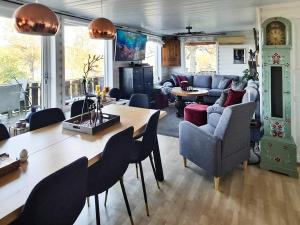 a living room with a large table and chairs at Holiday home Tau II in Tau