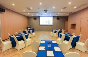 a conference room with blue tables and white chairs at Holiday Inn Express Shanghai Xuhui Binjiang, an IHG Hotel in Shanghai