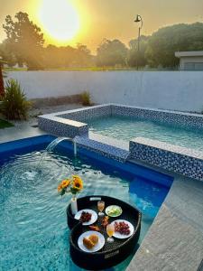 a pool with a tray of food in the water at A famosa resort villa 1054 in Kampong Alor Gajah