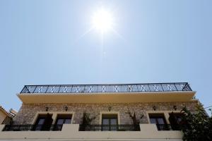 a building with the sun in the sky at Mpalkoni Sti Monemvasia in Monemvasia