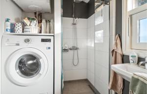 a white washing machine in a bathroom with a sink at Beautiful Home In Sams With Kitchen in Nordby