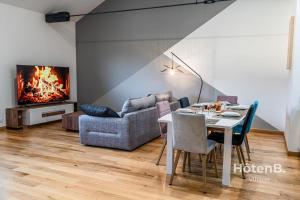 a living room with a table and a couch at Spacious Cocoon with AC and PARKING At the Heart of Feytiat Limoges in Feytiat