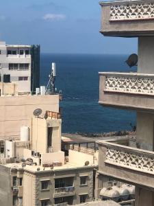 a view of the ocean from between two buildings at شقة in Alexandria
