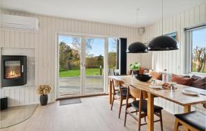 uma sala de estar com uma mesa e uma lareira em Nice Home In Sams With Wi-fi em Nordby