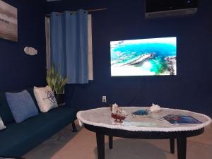 a living room with a couch and a table at Apartment near Grace Bay Beach in Providenciales