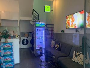 a living room with a couch and a flat screen tv at Elegant Hostel Sai Gon - District 3 in Ho Chi Minh City