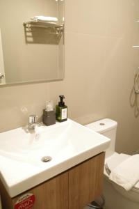 a bathroom with a white sink and a toilet at NOW’S HOSTEL in Ban Chang