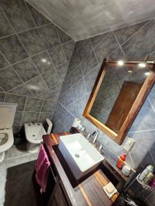 ein Bad mit einem Waschbecken und einem Spiegel in der Unterkunft Chalet Fer Icho in Villa Icho Cruz