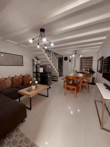 a living room with a couch and a table at The Doll House 2.0 in Abucay