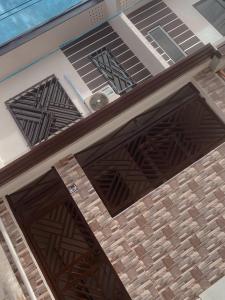 a set of wooden garage doors on a building at The Doll House 2.0 in Abucay