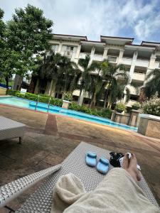 a person laying on a bench in front of a building at Sorrento Oasis 2 BR in Manila