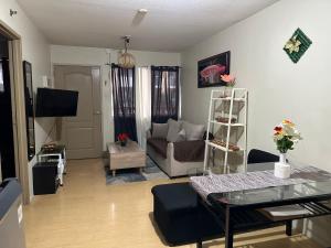 a living room with a couch and a table at Sorrento Oasis 2 BR in Manila