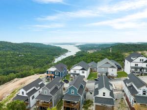 an aerial view of a subdivision of houses and a river at Serenity Point Lodge in Branson
