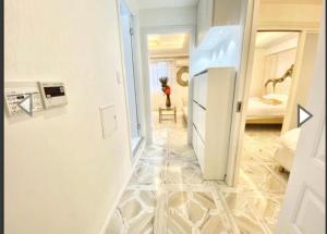 a hallway with a white refrigerator in a room at Reimi Mondo201 in Tokyo