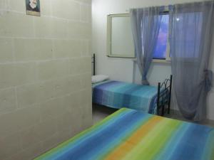 a room with two beds and a window at Casa Salento Mare in Torre Ovo
