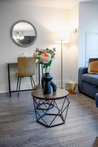 a living room with a vase with flowers on a table at Chic 1-BR Condo; Parking included; Downtown Core in Toronto