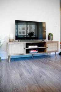 a entertainment center with a flat screen tv on it at Chic 1-BR Condo; Parking included; Downtown Core in Toronto