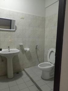 a bathroom with a toilet and a sink at Chai Ben guesthouse in Jomtien Beach