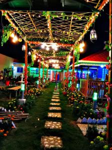 a house decorated with christmas lights in a garden at Banorupa Kuakata hotel in Kuākāta +93 photos