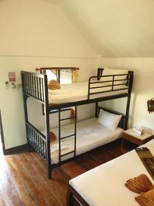 two bunk beds in a room with a room with another bed at Lanta Family resort in Ko Lanta