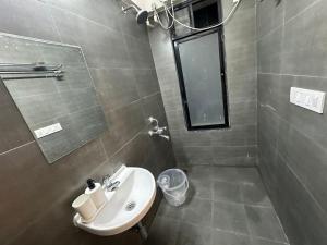 a bathroom with a sink and a mirror at 1bed room Mumbai theme Lower Parel in Mumbai