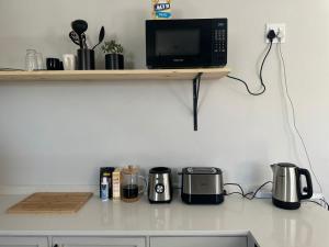a kitchen counter with a microwave and appliances on it at Ruach 5 in Bellville