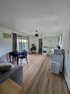 a living room with a couch and a table at Cottage for two, Marlo in Marlo +4 photos