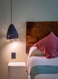 a bedroom with a bed with a wooden head board at Hotel Bindani’ in Santa Cruz Huatulco