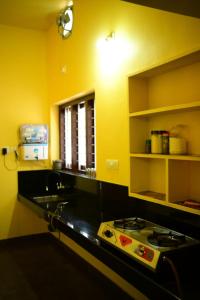 a kitchen with a sink and a stove in it at SILVERY MOON GRAND VILLA in Tariyod
