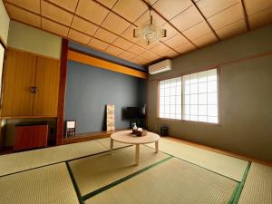 a living room with a table in the middle of a room at Yuzawa house in Yuzawa