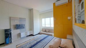 a room with a bed and a bathroom with a window at Apartemen Sentraland Semarang in Semarang