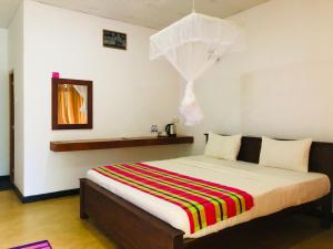 Letto o letti in una camera di Sungreen Cottage Sigiriya