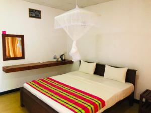 Letto o letti in una camera di Sungreen Cottage Sigiriya