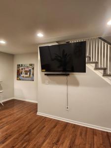 a living room with a flat screen tv on the wall at The Relaxation Oasis in Philadelphia