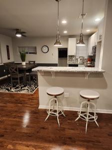 a kitchen with two stools and a counter in a kitchen at The Relaxation Oasis in Philadelphia