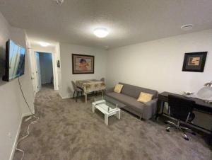 a living room with a couch and a table at Brand New One Bedroom Suite in Calgary