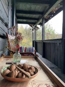a bowl of potatoes sitting on a table with a vase at Apusenia - darul naturii 