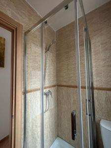 a shower with a glass door in a bathroom at Casa Cerro Luna in Constantina