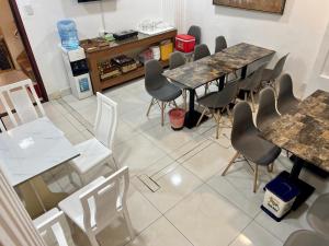 a room with tables and chairs in a restaurant at A25 Hotel - 167 Phạm Ngũ Lão in Ho Chi Minh City