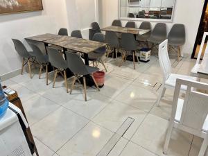 a room with a table and chairs on a tile floor at A25 Hotel - 167 Phạm Ngũ Lão in Ho Chi Minh City