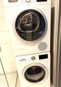 a washer and dryer stacked in a bathroom at Sissi Apartment Aleksandri 32 in Tartu