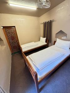 a bedroom with two beds in a room at bait bimah travel lodge in Bīmah