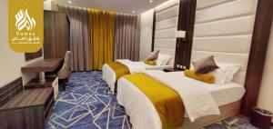Postel nebo postele na pokoji v ubytování شقق داماس للشقق المخدومة Damas Serviced Apartments