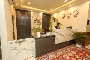 a man sitting at a counter in a lobby at The Mark in Islamabad
