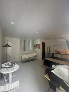 a bedroom with a bed and a table in it at edf torres ferreira in Lauro de Freitas