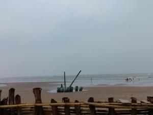 a boat is sitting on the beach near the ocean at Hotel Sea Coast in Digha