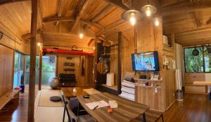 a living room with a table in a tiny house at 一棟貸しの移住案内古民家　itoma in Setouchi